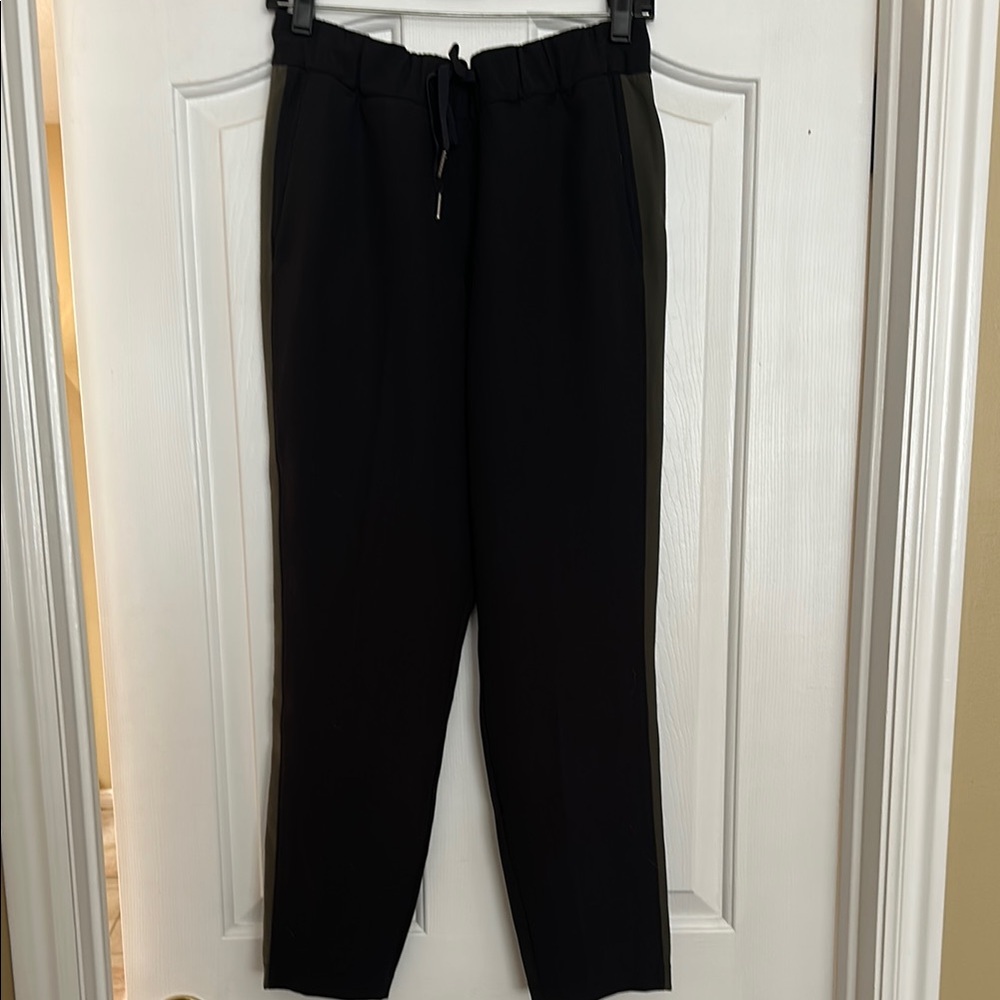 Lululemon Black On the Fly Pants w/side green stripe